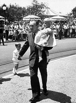 Walt Disney carries Tammy as he leads Christopher through Disneyland. Copyright Disney Enterprises, Inc. All rights reserved