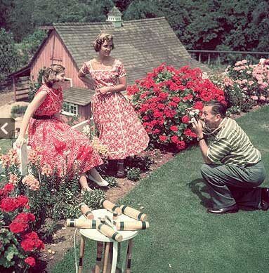 Walt takes a photo of his daughters Sharon & Diane in the backyard of the Disney family home in Holmby Hills