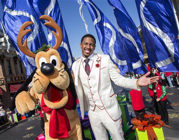 Nick Canon with pal reindeer Pluto at the Disneyland Christmas Day parade
