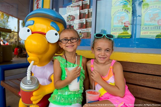 Universal Orlando Resort guests share a moment with Springfield's Milhouse in the Simpson area of the park