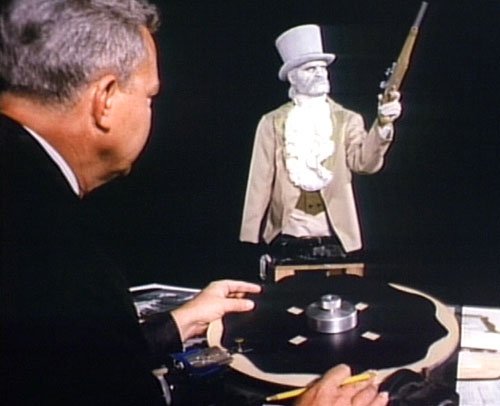 Disney Legend Bill Justice programs one of the dueling portraits for the Haunted Mansion at Disneyland